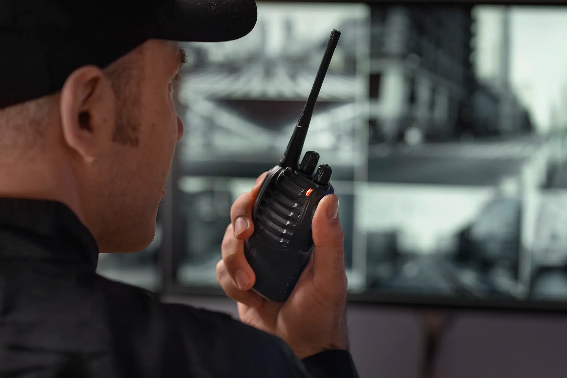 portrait-male-security-guard-with-radio-station-camera-screens copy